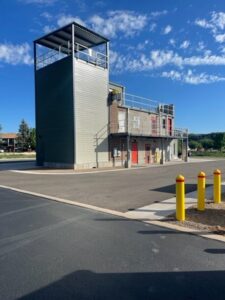 Fire training building under construction showing concrete and metal structure from rear perspective