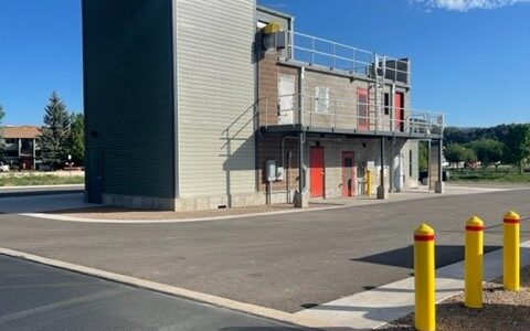 Fire training building under construction showing concrete and metal structure from rear perspective