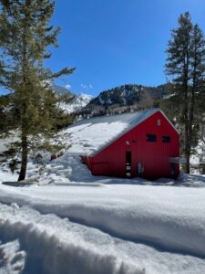 Exterior view of red Marble Fire Station building covered in snow