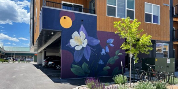 Mural painting of columbine flowers on side of Sopris Lofts building