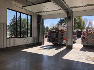 View through newly constructed Fire Station bay doors with fire engine parked in front - built by PNCI Construction