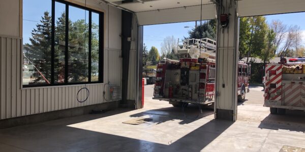 View through newly constructed Fire Station bay doors with fire engine parked in front - built by PNCI Construction