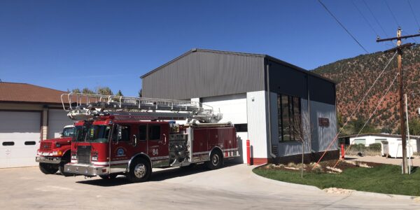 Photo of newly constructed fire engine bay addition built by PNCI construction with fire trucks parked in front