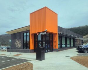 Exterior photo of newly constructed 1st Bank building in Basalt, CO showcasing distinctive custom orange entryway